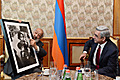 At the meeting with President Serzh Sargsyan the world-famous photographer Ara Güler presents him with one of his works